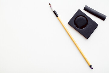 Abstract calligraphy brush and inkstone on white background. picture for add text or greeting card...
