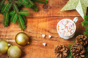 Christmas background. Spruce branches Christmas balls, cup with coffee with marshmallows and golden star on a wooden background. Copy space Top view. Christmas or New Year's card. flat lay