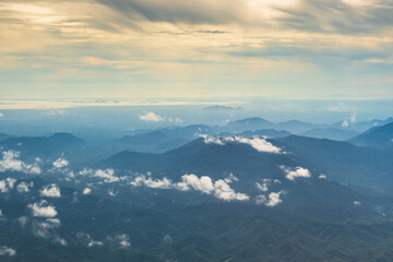 Aerial view of mountain hills with white cloud on the sunset time.