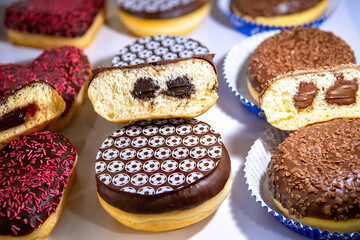 Assorted doughnuts with jelly filling. Cream Filled Donuts on table.