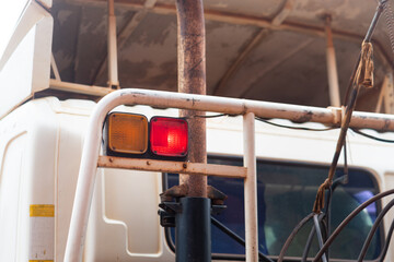 Braking and turning light signal on side of heavy trailer truck body. Transportation vehicle equipment object photo. Close-up and selective focus.
