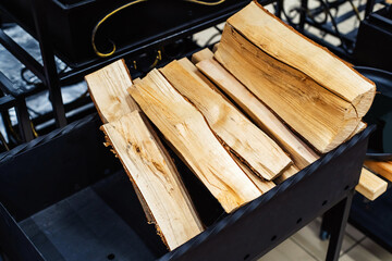 Metal brazier with wood. Trade in equipment for cooking on fire and charcoal. Close-up