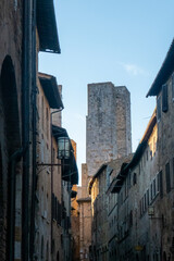 Fototapeta na wymiar Streets and buildings of little ancient town of San Gimignano, Tuscany, along via Francigena