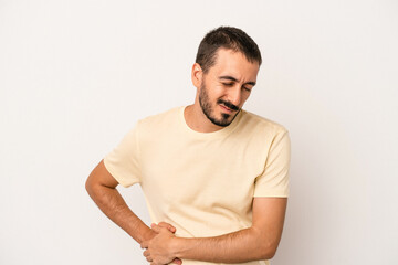 Young caucasian man isolated on white background having a liver pain, stomach ache.