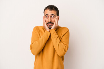 Young caucasian man isolated on white background scared and afraid.