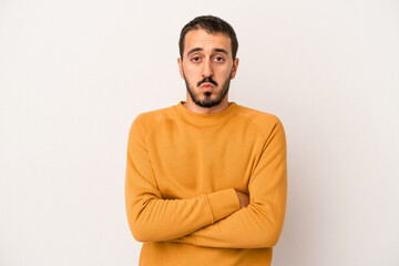 Obraz premium Young caucasian man isolated on white background blows cheeks, has tired expression. Facial expression concept.