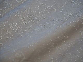 Drops of rain in the morning on a waterproof cloth
