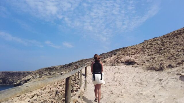 A young tourist walking on the path in the Cuevas de Ajuy, Pajara, west coast of the island of Fuerteventura, Canary Islands. Spain, video 4k