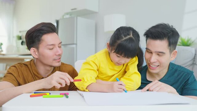 Asian attractive LGBTQ gay family teach young girl kid draw picture.