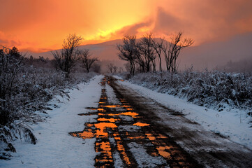 road in the snow at sunset 