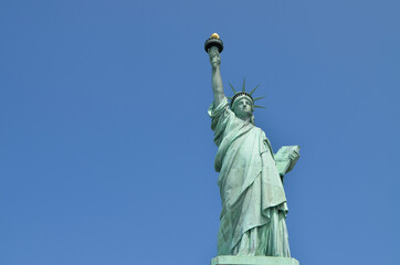 Statue of Liberty taken from below on a sunny day on blue sky background