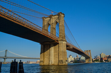 Fototapeta premium Brooklyn Bridge seen from Manhattan side with Brooklyn cityscape in the background