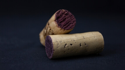 Two corks on a dark background