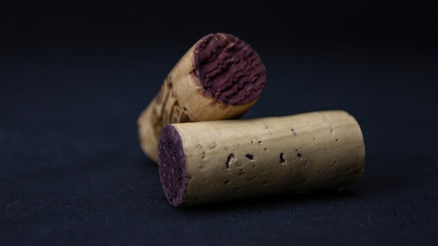 Two corks on a dark background