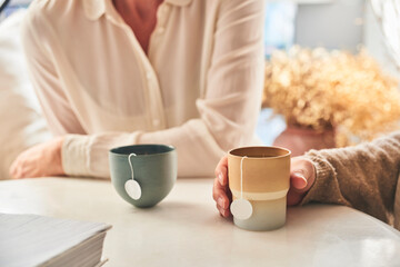 Two girls enjoying a meeting drinking tea in clean environment