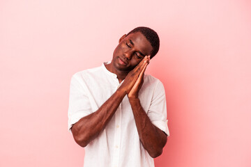Young African American man isolated on pink background yawning showing a tired gesture covering...