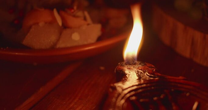 Antique Roman Empire style rushlight in darkness.