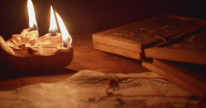 Antoque Rushlight on table in darkness.