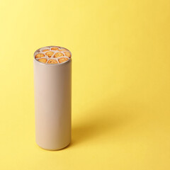 Gray grey tin can with biscuits selection on yellow background concept minimal aesthetic. Danish...
