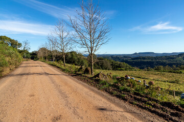 Dirty road with Forest, mountains and valley