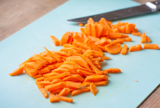 Chopped carrots on a plank. Cutting carrots into strips