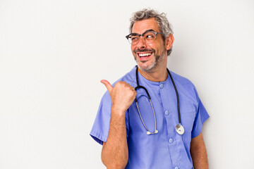 Middle age nurse caucasian man isolated on white background  points with thumb finger away, laughing and carefree.