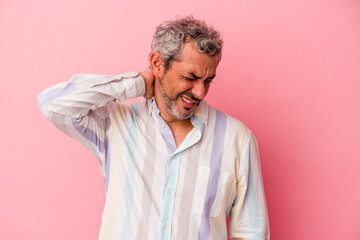 Middle age caucasian man isolated on pink background  suffering neck pain due to sedentary lifestyle.