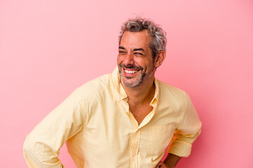 Middle age caucasian man isolated on pink background  confident keeping hands on hips.