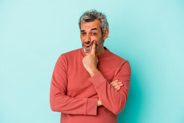 Middle age caucasian man isolated on blue background  unhappy looking in camera with sarcastic expression.