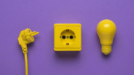 A cord with a plug, an electrical outlet and an incandescent lamp on a purple background.