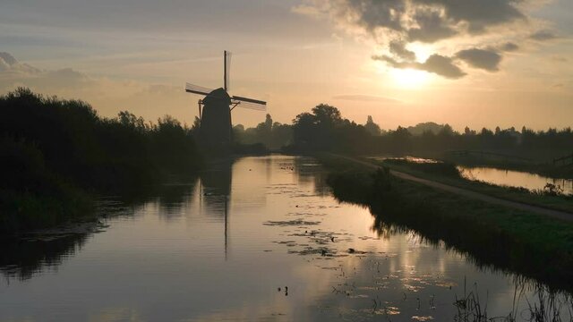 Calm and foggy golden sunrise morning on the Hazerswouder-Dorp windmill,  Rietveldse, Netherlands.