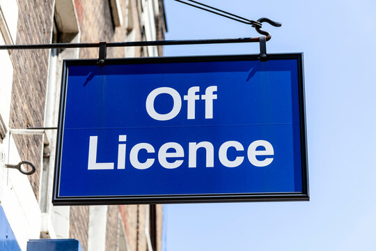 London, UK, May 27, 2012 : Off Licence or liquor store blue advertising logo sign outside the entrance to an alcohol retail business selling bottle beer and wine in the city centre, stock photo image