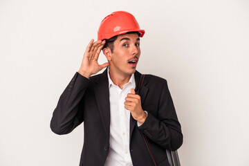 Young architect mixed race man isolated on white background trying to listening a gossip.
