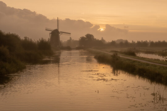 Calm and foggy golden sunrise morning on the Hazerswouder-Dorp windmill,  Rietveldse, Netherlands.