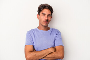 Young mixed race man isolated on white background suspicious, uncertain, examining you.