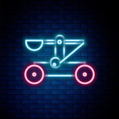 Glowing neon line Old medieval wooden catapult shooting stones icon isolated on brick wall background. Colorful outline concept. Vector