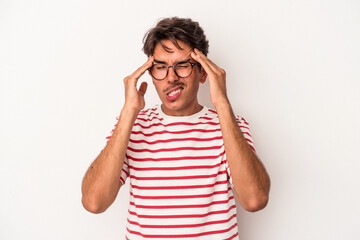 Naklejka premium Young mixed race man isolated on white background touching temples and having headache.