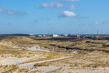 Dune landscape with hills, marram grass, hiking trails and the reactor center for the production of...