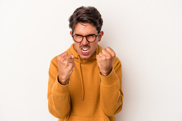 Young mixed race man isolated on white background upset screaming with tense hands.