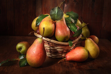 pears in a basket on a dark wooden background in a rustic style