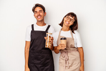 Young mixed race store clerk couple isolated on white background happy, smiling and cheerful.