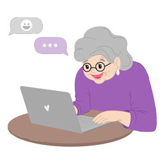Cute happy grandmother is sitting at the laptop.