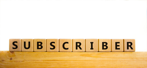 Subscriber symbol. The word Subscriber on wooden cubes. Beautiful wooden table, white background. Business and subscriber concept. Copy space.
