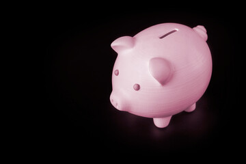 Pink blue piggy bank on a black background with place for text, copy space. Concept for 3D printing from plastic. Close-up
