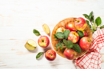 Apples. Fresh ripe red apples in the basket at white table. Top view.