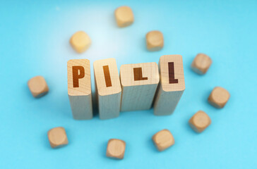 On a blue background, wooden cubes and Jenga with the inscription - PILL