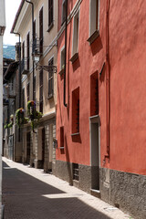 Front of a red ochre house in an alley in Italy