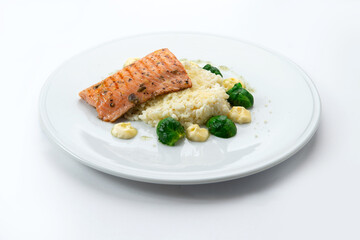 Salmon steak with rice and cauliflower in a plate.