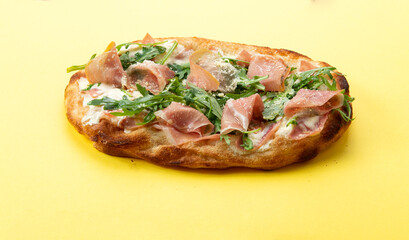 Roman pizza with ham and arugula.