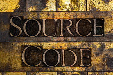 Source Code text on textured grunge copper and vintage gold background
